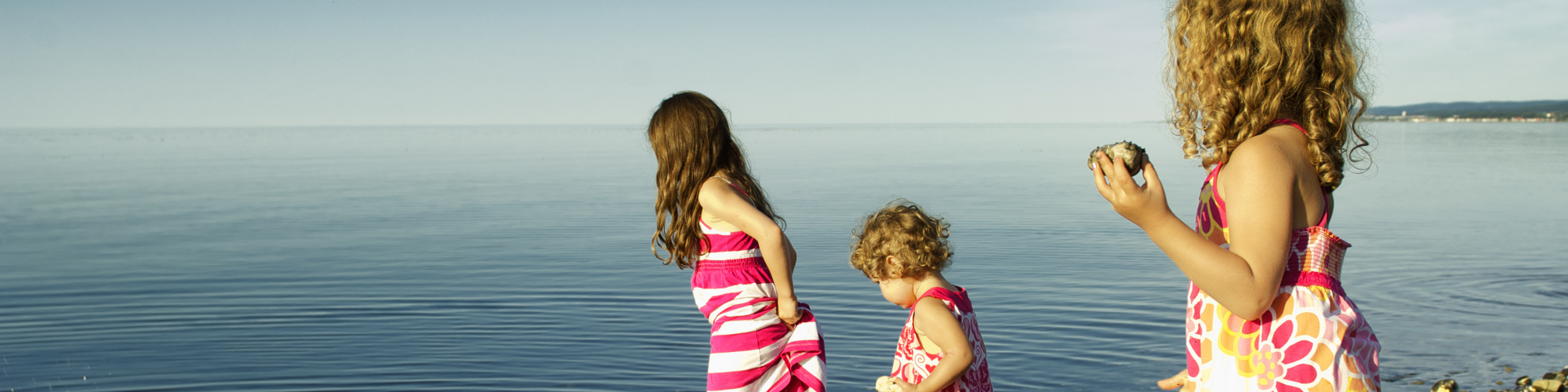 Children playing in the water, by the sea