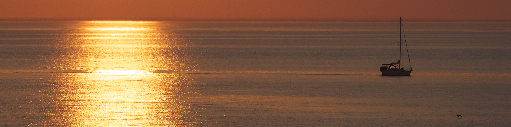 Sailboat at sea, sunset