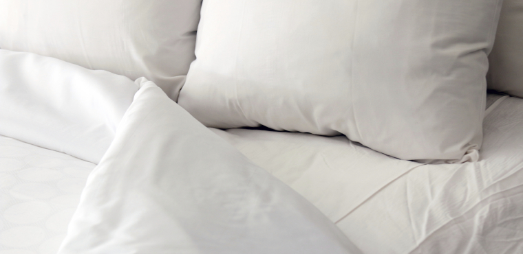White bed, pillows and duvet