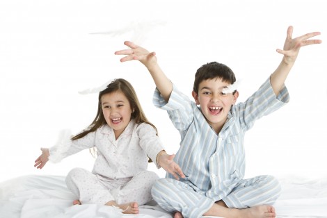 Children sitting on a bed