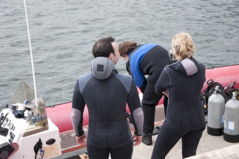 Person on a boat, getting ready to scuba dive