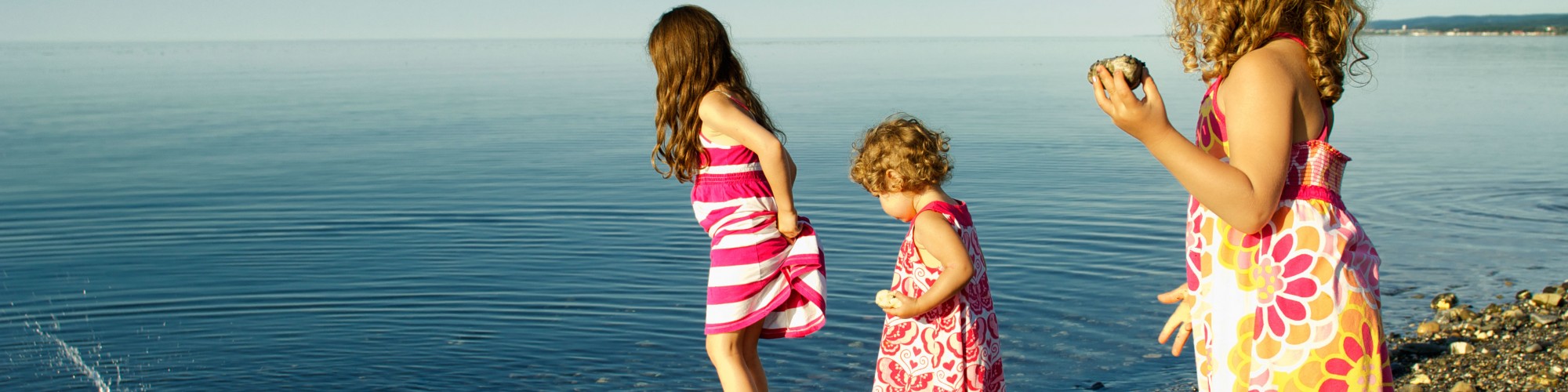 3 little girls playing in the water, on the beach