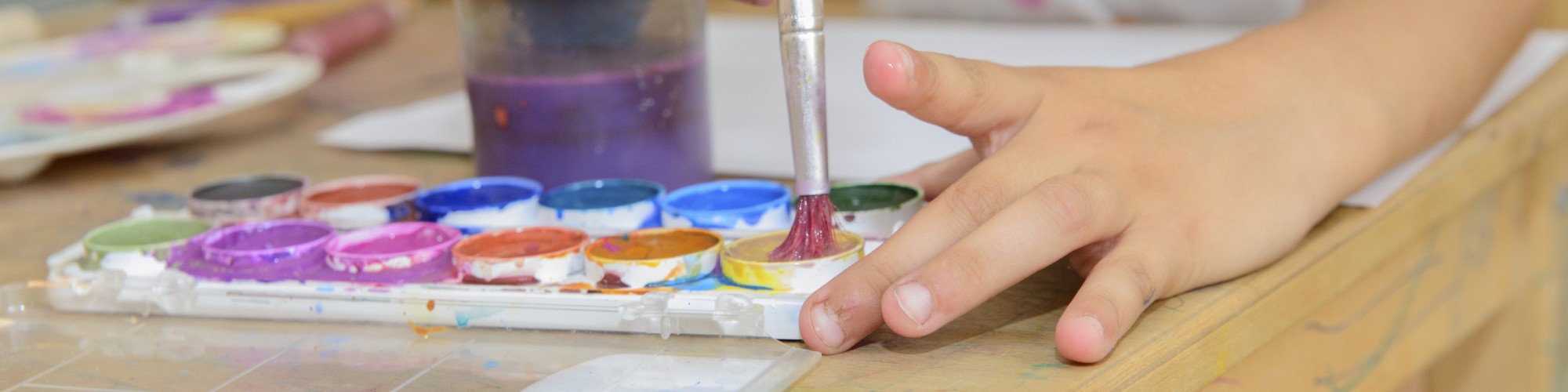 Child painting with watercolours